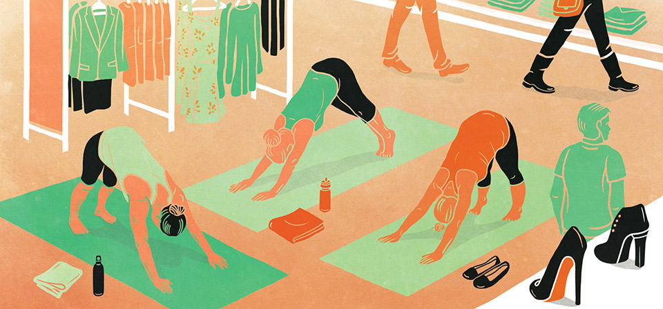Three women doing a downward dog pose on a yoga mat in the middle of a department store